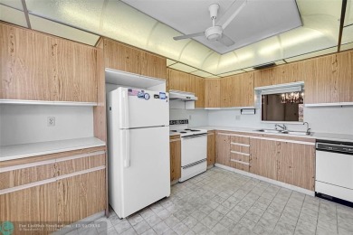 Deluxe Spacious Corner, Screened  Enclosed Balcony with Lake on Wynmoor Golf Course in Florida - for sale on GolfHomes.com, golf home, golf lot