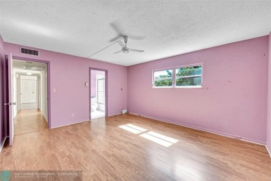Deluxe Spacious Corner, Screened  Enclosed Balcony with Lake on Wynmoor Golf Course in Florida - for sale on GolfHomes.com, golf home, golf lot