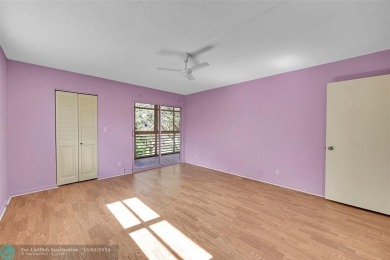 Deluxe Spacious Corner, Screened  Enclosed Balcony with Lake on Wynmoor Golf Course in Florida - for sale on GolfHomes.com, golf home, golf lot