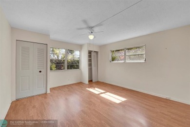 Deluxe Spacious Corner, Screened  Enclosed Balcony with Lake on Wynmoor Golf Course in Florida - for sale on GolfHomes.com, golf home, golf lot