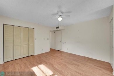 Deluxe Spacious Corner, Screened  Enclosed Balcony with Lake on Wynmoor Golf Course in Florida - for sale on GolfHomes.com, golf home, golf lot