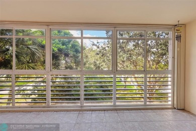 Deluxe Spacious Corner, Screened  Enclosed Balcony with Lake on Wynmoor Golf Course in Florida - for sale on GolfHomes.com, golf home, golf lot