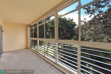 Deluxe Spacious Corner, Screened  Enclosed Balcony with Lake on Wynmoor Golf Course in Florida - for sale on GolfHomes.com, golf home, golf lot