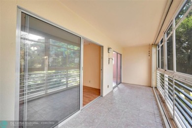 Deluxe Spacious Corner, Screened  Enclosed Balcony with Lake on Wynmoor Golf Course in Florida - for sale on GolfHomes.com, golf home, golf lot