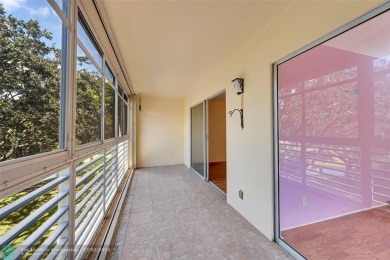 Deluxe Spacious Corner, Screened  Enclosed Balcony with Lake on Wynmoor Golf Course in Florida - for sale on GolfHomes.com, golf home, golf lot