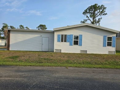 This lovely 2-bedroom partially furnished home on a corner lot on Pine Lakes Country Club in Florida - for sale on GolfHomes.com, golf home, golf lot