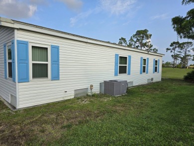 This lovely 2-bedroom partially furnished home on a corner lot on Pine Lakes Country Club in Florida - for sale on GolfHomes.com, golf home, golf lot