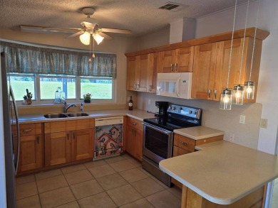 This lovely 2-bedroom partially furnished home on a corner lot on Pine Lakes Country Club in Florida - for sale on GolfHomes.com, golf home, golf lot