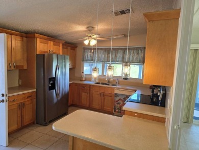 This lovely 2-bedroom partially furnished home on a corner lot on Pine Lakes Country Club in Florida - for sale on GolfHomes.com, golf home, golf lot
