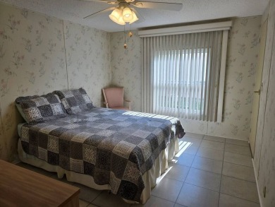 This lovely 2-bedroom partially furnished home on a corner lot on Pine Lakes Country Club in Florida - for sale on GolfHomes.com, golf home, golf lot