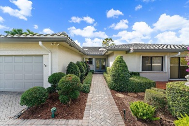 Enjoy golf and water views from this charming one-story on Delray Dunes Golf and Country Club in Florida - for sale on GolfHomes.com, golf home, golf lot