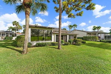 Enjoy golf and water views from this charming one-story on Delray Dunes Golf and Country Club in Florida - for sale on GolfHomes.com, golf home, golf lot