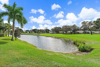 Enjoy golf and water views from this charming one-story on Delray Dunes Golf and Country Club in Florida - for sale on GolfHomes.com, golf home, golf lot