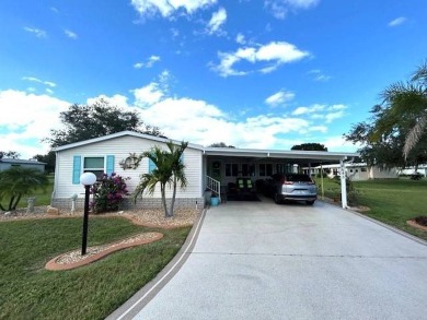 This charming cottage-style home radiates the essence of a sunny on Crystal Lake Club in Florida - for sale on GolfHomes.com, golf home, golf lot