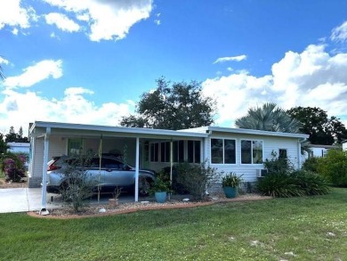 This charming cottage-style home radiates the essence of a sunny on Crystal Lake Club in Florida - for sale on GolfHomes.com, golf home, golf lot