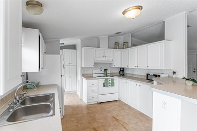 Enjoy easy coastal living in this fully furnished 3-bedroom on Barefoot Bay Golf Course in Florida - for sale on GolfHomes.com, golf home, golf lot