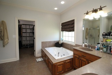 Spacious and elegant 5-bedroom, 3-bath home situated on a on Paragould Country Club in Arkansas - for sale on GolfHomes.com, golf home, golf lot