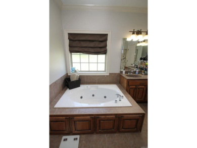Spacious and elegant 5-bedroom, 3-bath home situated on a on Paragould Country Club in Arkansas - for sale on GolfHomes.com, golf home, golf lot