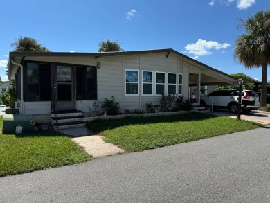 This home is set up to enjoy the Florida lifestyle! This on Lake Henry Golf Club in Florida - for sale on GolfHomes.com, golf home, golf lot