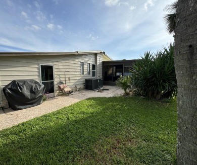 This home is set up to enjoy the Florida lifestyle! This on Lake Henry Golf Club in Florida - for sale on GolfHomes.com, golf home, golf lot