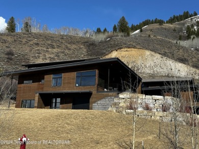 Indulge in the ultimate mountain retreat with this fully on Snake River Sporting Club in Wyoming - for sale on GolfHomes.com, golf home, golf lot