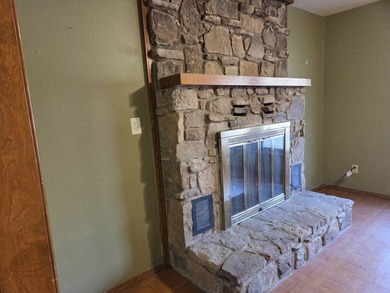 Welcome home to this inviting 3-bedroom, all-electric property on Cherokee Village South Course in Arkansas - for sale on GolfHomes.com, golf home, golf lot