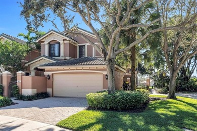 Immaculate corner residence with serene views of lush greenery on Weston Hills Country Club in Florida - for sale on GolfHomes.com, golf home, golf lot