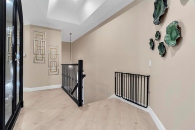 Immaculate corner residence with serene views of lush greenery on Weston Hills Country Club in Florida - for sale on GolfHomes.com, golf home, golf lot