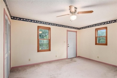 This private and secluded two story home sits on a huge, treed on Loch Lloyd Country Club in Missouri - for sale on GolfHomes.com, golf home, golf lot