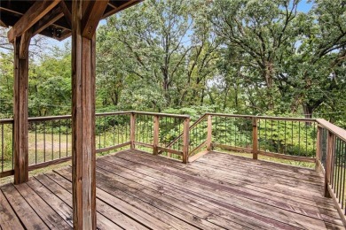 This private and secluded two story home sits on a huge, treed on Loch Lloyd Country Club in Missouri - for sale on GolfHomes.com, golf home, golf lot