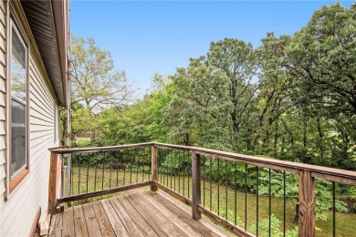 This private and secluded two story home sits on a huge, treed on Loch Lloyd Country Club in Missouri - for sale on GolfHomes.com, golf home, golf lot