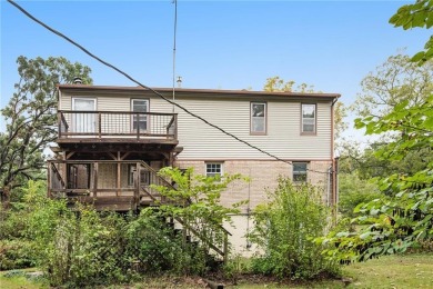 This private and secluded two story home sits on a huge, treed on Loch Lloyd Country Club in Missouri - for sale on GolfHomes.com, golf home, golf lot
