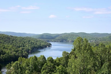 Perched above Lake Burton overlooking stunning views of the lake on Waterfall Country Club in Georgia - for sale on GolfHomes.com, golf home, golf lot