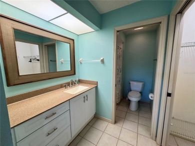 Well maintained END UNIT with WATER VIEW, spacious HIGH CEILINGS on The Meadows Golf and Country Club in Florida - for sale on GolfHomes.com, golf home, golf lot