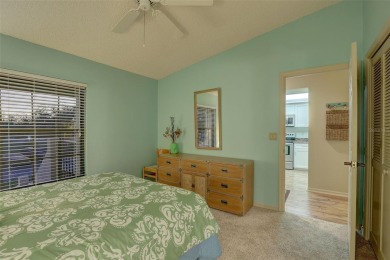 Well maintained END UNIT with WATER VIEW, spacious HIGH CEILINGS on The Meadows Golf and Country Club in Florida - for sale on GolfHomes.com, golf home, golf lot