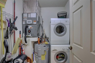 Well maintained END UNIT with WATER VIEW, spacious HIGH CEILINGS on The Meadows Golf and Country Club in Florida - for sale on GolfHomes.com, golf home, golf lot