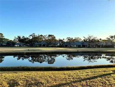Well maintained END UNIT with WATER VIEW, spacious HIGH CEILINGS on The Meadows Golf and Country Club in Florida - for sale on GolfHomes.com, golf home, golf lot
