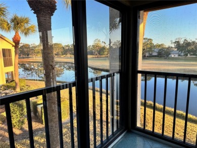 Well maintained END UNIT with WATER VIEW, spacious HIGH CEILINGS on The Meadows Golf and Country Club in Florida - for sale on GolfHomes.com, golf home, golf lot