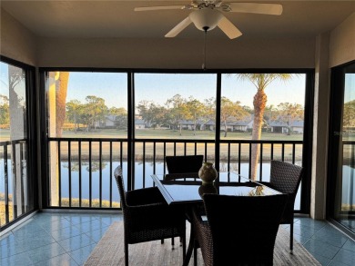Well maintained END UNIT with WATER VIEW, spacious HIGH CEILINGS on The Meadows Golf and Country Club in Florida - for sale on GolfHomes.com, golf home, golf lot