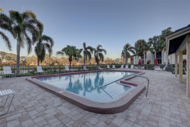 Well maintained END UNIT with WATER VIEW, spacious HIGH CEILINGS on The Meadows Golf and Country Club in Florida - for sale on GolfHomes.com, golf home, golf lot