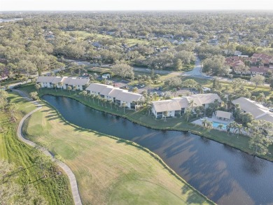 Well maintained END UNIT with WATER VIEW, spacious HIGH CEILINGS on The Meadows Golf and Country Club in Florida - for sale on GolfHomes.com, golf home, golf lot