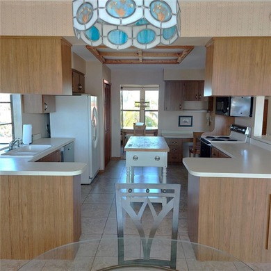 This Key West style Elevated home did not flood during hurricane on Gulf Harbors Golf Course in Florida - for sale on GolfHomes.com, golf home, golf lot