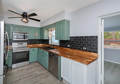 BEAUTIFULLY UPDATED CORNER LOT CHARMER with MAJOR UPDATES! on Oyster Creek Golf Club in Florida - for sale on GolfHomes.com, golf home, golf lot