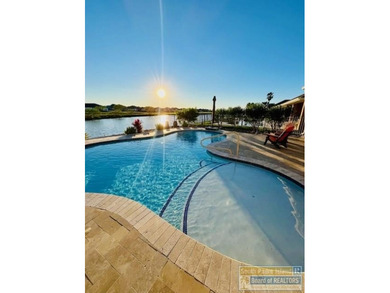 Experience refined lakefront living in this beautifully on South Padre Island Golf Club in Texas - for sale on GolfHomes.com, golf home, golf lot