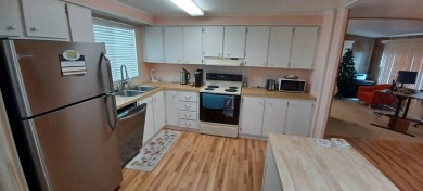 Come settle down and relax in a beautiful, manufactured home on Fairways Country Club in Florida - for sale on GolfHomes.com, golf home, golf lot