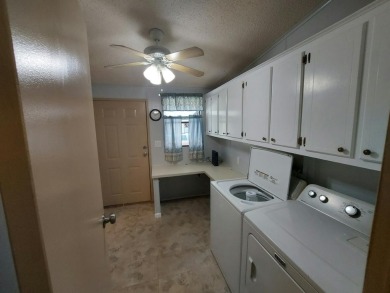 Air conditioned lanai & screened in porch are 2 ways to enjoy on Lakes at Leesburg Golf Course in Florida - for sale on GolfHomes.com, golf home, golf lot
