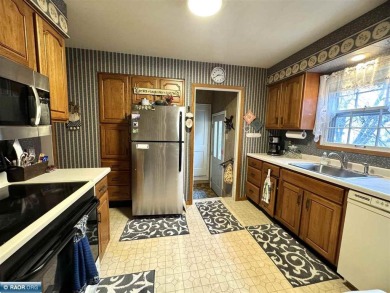 Discover this charming 3-bed, 2.75-bath gem overlooking the lush on Virginia Golf Course in Minnesota - for sale on GolfHomes.com, golf home, golf lot