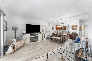 Immaculate first floor end-unit townhome showcasing tranquil on Riverbend Golf Club in Florida - for sale on GolfHomes.com, golf home, golf lot