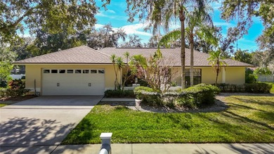 This four bedroom, 3 and a half bathroom pool home is nestled in on Tampa Palms Golf and Country Club in Florida - for sale on GolfHomes.com, golf home, golf lot