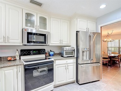 This four bedroom, 3 and a half bathroom pool home is nestled in on Tampa Palms Golf and Country Club in Florida - for sale on GolfHomes.com, golf home, golf lot